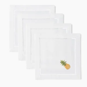 Henry Handwork white linen cocktail napkins with hemstitch border and pineapple embroidery.