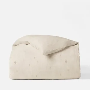 Coyuchi Cambria Embroidered Linen duvet cover in natural with small diamond motifs.