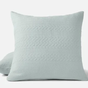 Coyuchi Angeles Matelasse pillow sham in mist blue with herringbone quilted texture.