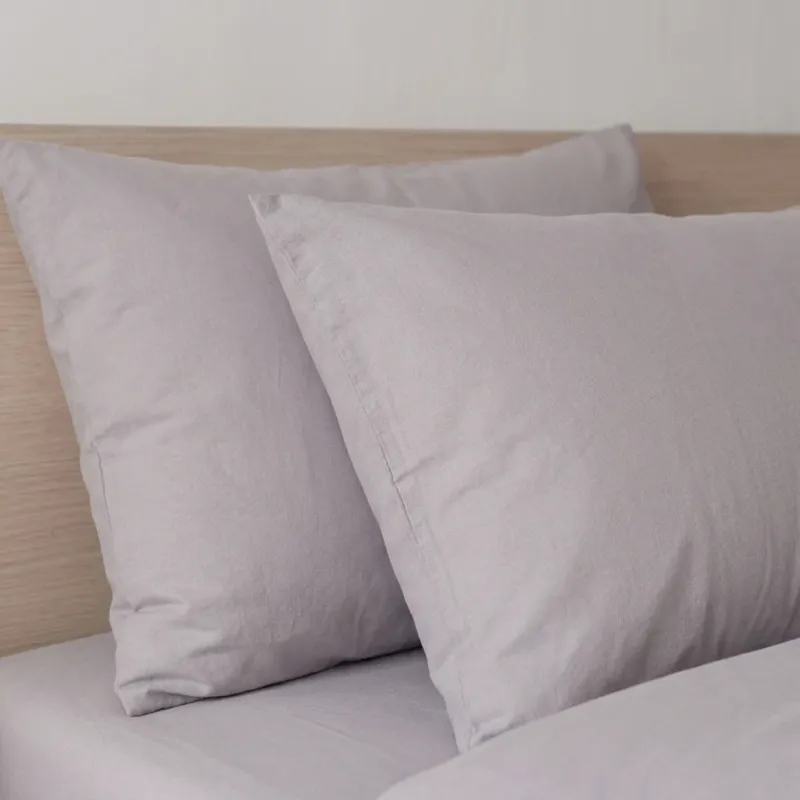 Deux taies d'oreiller en percale de coton 100 fils/cm², texture lisse et fraîcheur naturelle.